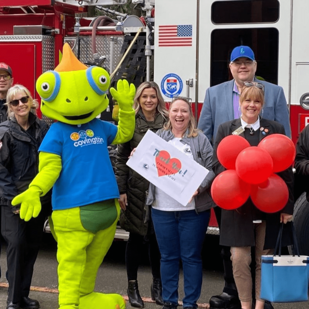 Kristina Soltys with a group by a fire truck and mascot
